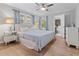 Bright bedroom with a queen-sized bed, ceiling fan, and doorway to the en-suite bathroom at 114 California Ave, Moncks Corner, SC 29461
