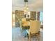Dining area features a wooden table, upholstered chairs, brick accent wall and stylish lighting at 114 California Ave, Moncks Corner, SC 29461