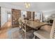 Inviting dining area with brick accents, stylish chairs, an area rug, and great flow to kitchen at 114 California Ave, Moncks Corner, SC 29461
