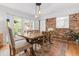 Bright dining room features a wooden table, brick wall, rug, and natural light at 114 California Ave, Moncks Corner, SC 29461