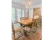 Sunlit dining room showcasing a wooden table, stylish chairs, accent rug, and adjacent brick wall at 114 California Ave, Moncks Corner, SC 29461