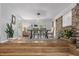 Spacious dining room with hardwood floors, large table, and access to outdoor views at 114 California Ave, Moncks Corner, SC 29461