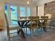 Cozy dining room with a wooden table, accent rug, and lots of natural light at 114 California Ave, Moncks Corner, SC 29461