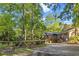 Charming brick home featuring a large front yard with mature trees and gated fence at 114 California Ave, Moncks Corner, SC 29461