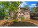 Brick home exterior surrounded by towering trees and landscaped yard at 114 California Ave, Moncks Corner, SC 29461
