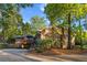Brick home showcasing a back deck and a landscaped yard with mature trees at 114 California Ave, Moncks Corner, SC 29461