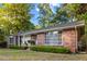Classic brick home with mature trees, tidy landscaping, and welcoming front porch creates curb appeal at 114 California Ave, Moncks Corner, SC 29461