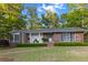 Inviting brick home with a well-manicured lawn, brick path and lush green landscaping around the perimeter at 114 California Ave, Moncks Corner, SC 29461