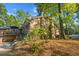 Brick home exterior with a deck area, complemented by mature trees and landscaping at 114 California Ave, Moncks Corner, SC 29461