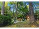 Charming cabin featuring an outdoor fire pit with chairs and surrounded by a beautiful wooded lot at 114 California Ave, Moncks Corner, SC 29461
