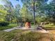 Outdoor fire pit surrounded by four chairs, perfect for enjoying time with friends and Gathering at 114 California Ave, Moncks Corner, SC 29461