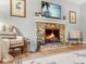 Close-up of fireplace and mantle and some of the seating in the living room at 114 California Ave, Moncks Corner, SC 29461