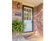 Charming brick home featuring a decorative front door with sidelights, wreath, and manicured front garden at 114 California Ave, Moncks Corner, SC 29461