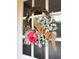 A charming wreath with pink and burlap bow adds a welcoming touch to the front door at 114 California Ave, Moncks Corner, SC 29461