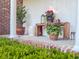 Welcoming front porch with potted plants, flowers, a bench, and views of manicured landscaping at 114 California Ave, Moncks Corner, SC 29461