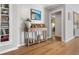 Elegant hallway featuring laminate floors, decorative console table, and access to other rooms at 114 California Ave, Moncks Corner, SC 29461