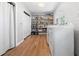 Bright laundry room with wood floor, storage shelves and white washer and dryer at 114 California Ave, Moncks Corner, SC 29461