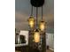 Stylish pendant lights hang above a brick wall in the dining area at 114 California Ave, Moncks Corner, SC 29461