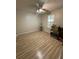 Bright, spacious bedroom with wood floors, ample natural light from a window, ceiling fan, and a guitar at 1220 Apex Ln, Charleston, SC 29412