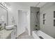 Bathroom featuring a modern vanity, granite countertops, and a bathtub with shower and neutral wall tiles at 1300 Park West Blvd # 101, Mount Pleasant, SC 29466