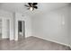 A well-lit bedroom with hardwood floors and an ensuite bathroom with a shower and toilet at 1300 Park West Blvd # 101, Mount Pleasant, SC 29466