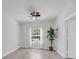 A clean, simple bedroom featuring hardwood floors and natural light from the window at 1300 Park West Blvd # 101, Mount Pleasant, SC 29466