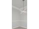 A modern lighting fixture is centrally mounted over an empty room with crown molding and chair railing at 1300 Park West Blvd # 101, Mount Pleasant, SC 29466