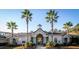 Exterior view of the community clubhouse with palm trees, offering residents a central gathering space at 1300 Park West Blvd # 101, Mount Pleasant, SC 29466
