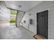 Exterior entryway features a black front door with a welcome mat and convenient access to a staircase at 1300 Park West Blvd # 101, Mount Pleasant, SC 29466