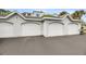 A row of white garages, providing ample parking and storage space for residents at 1300 Park West Blvd # 101, Mount Pleasant, SC 29466