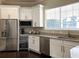 Modern kitchen with stainless steel appliances and granite countertops offering sleek functionality and style at 1300 Park West Blvd # 101, Mount Pleasant, SC 29466