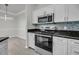 Modern kitchen featuring stainless steel appliances, granite countertops and white cabinets at 1300 Park West Blvd # 101, Mount Pleasant, SC 29466