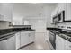 Modern kitchen featuring stainless steel appliances, granite countertops and white cabinets at 1300 Park West Blvd # 101, Mount Pleasant, SC 29466