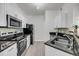Modern kitchen featuring stainless steel appliances, granite countertops and white cabinets at 1300 Park West Blvd # 101, Mount Pleasant, SC 29466