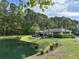 Scenic lakeside amenity with seating, grill, and covered picnic area, perfect for outdoor gatherings at 1300 Park West Blvd # 101, Mount Pleasant, SC 29466