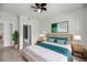 Comfortable main bedroom with ensuite, hardwood floors, lamps on bedside tables, and a padded headboard at 1300 Park West Blvd # 101, Mount Pleasant, SC 29466
