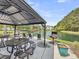 Outdoor grill and seating overlook the calm waters of the pond at 1300 Park West Blvd # 101, Mount Pleasant, SC 29466