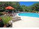 Beautiful pool area with an orange umbrella, a great spot for relaxation on a sunny day at 1300 Park West Blvd # 101, Mount Pleasant, SC 29466