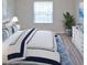Comfortable bedroom features plush bedding, a bright window, and stylish decor at 1300 Park West Blvd # 406, Mount Pleasant, SC 29466