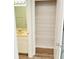 Walk-in closet with wire shelving next to a well-lit bathroom at 1300 Park West Blvd # 406, Mount Pleasant, SC 29466
