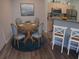 Cozy dining area with seating for four next to the kitchen featuring a breakfast bar at 1300 Park West Blvd # 406, Mount Pleasant, SC 29466