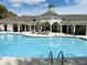 Community pool with ample lounge chairs on the deck, perfect for relaxation and social gatherings at 1300 Park West Blvd # 406, Mount Pleasant, SC 29466