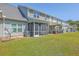 Townhome backyard features a well-maintained lawn and screened-in patio, perfect for relaxing outdoors at 131 Buchanan Cir, Goose Creek, SC 29445