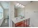 Bathroom with double sink vanity, wood cabinets, large mirror, and natural light at 131 Buchanan Cir, Goose Creek, SC 29445