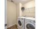 Functional laundry room with washer, dryer, wire shelving, and tile floor at 131 Buchanan Cir, Goose Creek, SC 29445