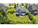 Aerial shot of the home showcasing the backyard with a patio, fire pit, and lush greenery and landscaping at 1325 Whisker Pole Ln, Mount Pleasant, SC 29466