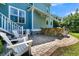 Inviting backyard with patio, outdoor kitchen, and white Adirondack chairs near stairs at 1325 Whisker Pole Ln, Mount Pleasant, SC 29466