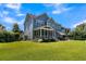 Spacious backyard featuring a screened porch, patio, and lush green lawn perfect for outdoor entertaining at 1325 Whisker Pole Ln, Mount Pleasant, SC 29466