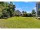 Expansive backyard with well-maintained lawn, mature trees, and recreational features, ideal for Gathering enjoyment at 1325 Whisker Pole Ln, Mount Pleasant, SC 29466