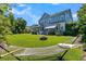 Lush backyard with hammock, fire pit, outdoor kitchen, and view of a charming two-story home at 1325 Whisker Pole Ln, Mount Pleasant, SC 29466